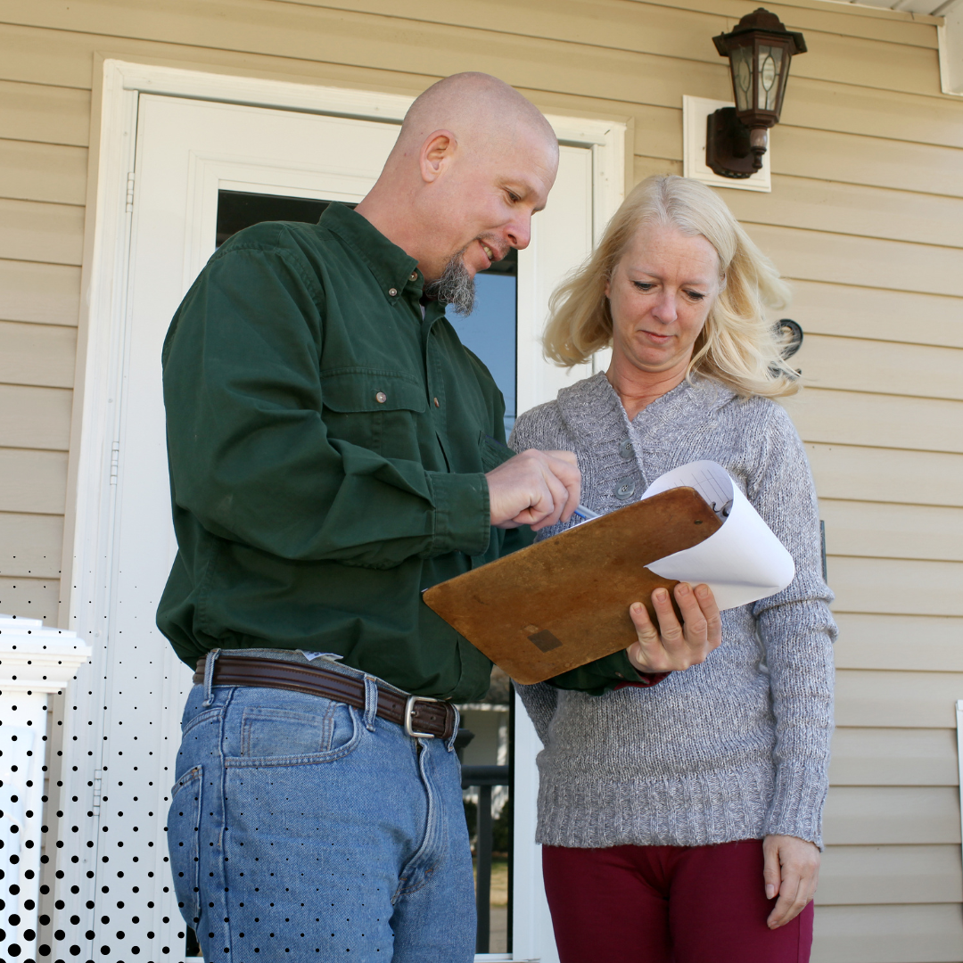 The homeowner and home inspector discuss the inspection report on a clipboard.