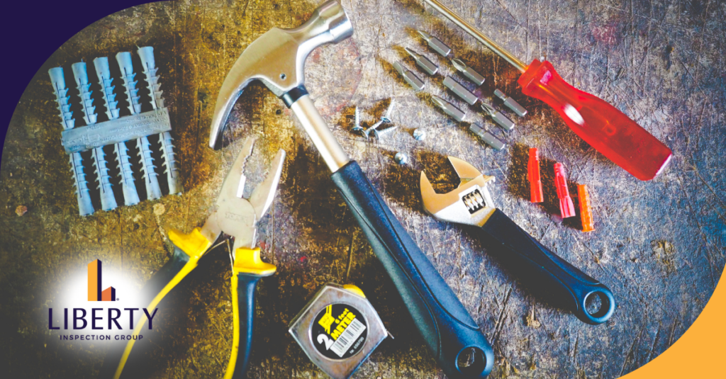 Various home inspection tools including a hammer, pliers, adjustable wrench, and screwdriver