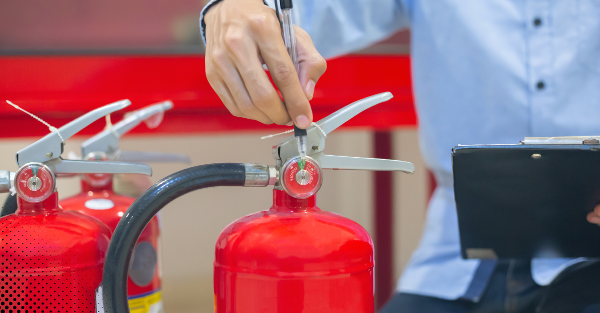 Inspector examining a fire extinguisher