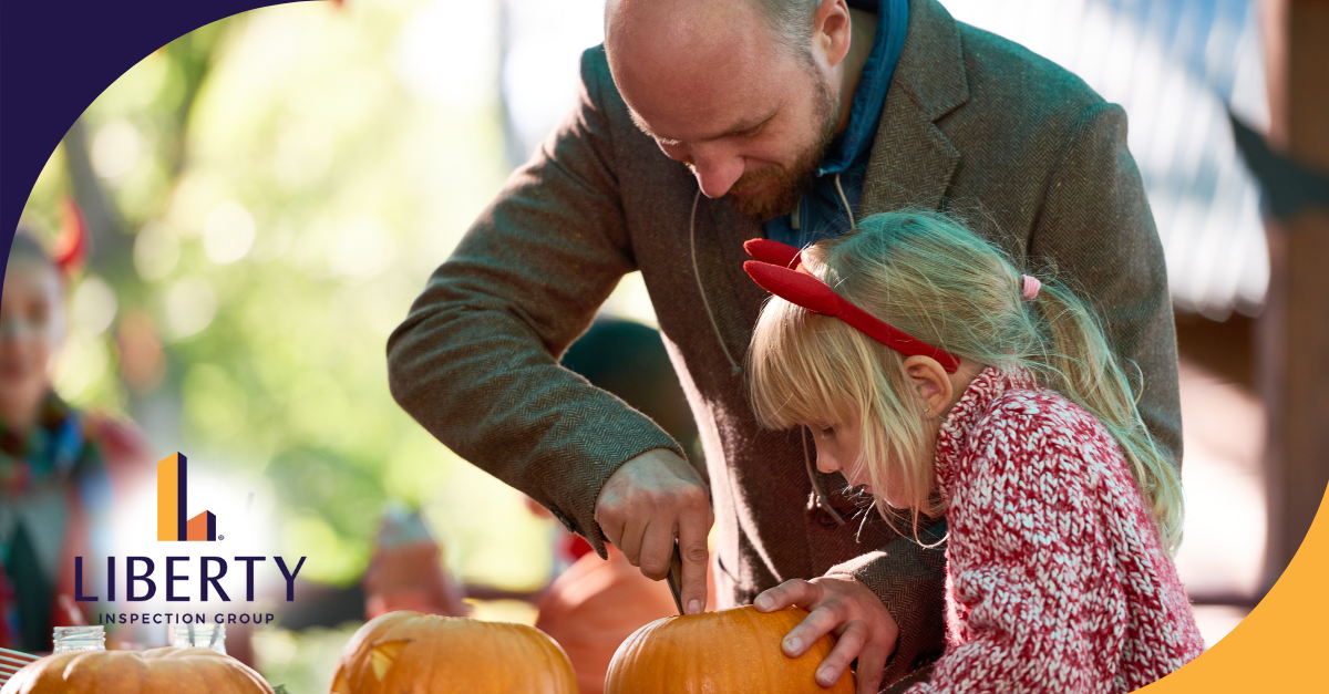 Father and daughter carving pumpkins together